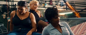 Movie still from “Set It Off” (1996), directed by F. Gary Gray – A group of women sitting next to each other in a room; Medium shot, Over the shoulder angle