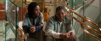 Movie still from “Set It Off” (1996), directed by F. Gary Gray – Two women sitting next to each other on the stairs; Medium shot, Low angle