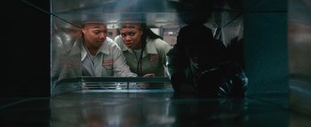 Movie still from “Set It Off” (1996), directed by F. Gary Gray – A couple of people that are looking at something; Medium shot, Low angle