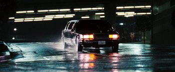 Movie still from “Set It Off” (1996), directed by F. Gary Gray – A car driving down a street at night; Wide shot, Low angle