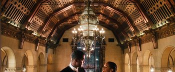 Movie still from “Set It Off” (1996), directed by F. Gary Gray – A man and a woman standing next to each other in front of chandeliers; Wide shot, Low angle