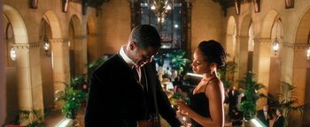 Movie still from “Set It Off” (1996), directed by F. Gary Gray – A man and a woman holding wine glasses in a room; Medium shot, Over the shoulder angle