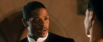 Movie still from “Set It Off” (1996), directed by F. Gary Gray – A person wearing a suit and tie; Close Up shot, Over the shoulder angle