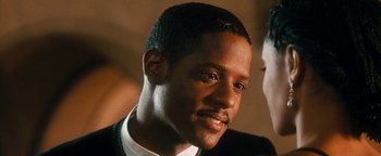 Movie still from “Set It Off” (1996), directed by F. Gary Gray – A person wearing a suit and tie; Close Up shot, Over the shoulder angle