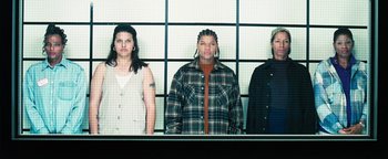 Movie still from “Set It Off” (1996), directed by F. Gary Gray – A group of people standing next to each other in front of a wall; Medium shot, Low angle