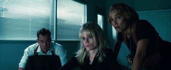 Movie still from “Set It Off” (1996), directed by F. Gary Gray – A group of people standing in a dark room; Medium shot, Low angle