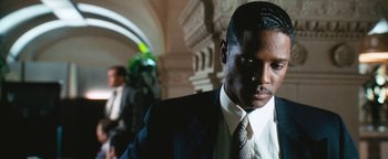 Movie still from “Set It Off” (1996), directed by F. Gary Gray – A man in a suit and tie; Close Up shot, Low angle