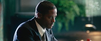 Movie still from “Set It Off” (1996), directed by F. Gary Gray – A person wearing a suit and tie; Close Up shot, Over the shoulder angle