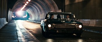 Movie still from “Set It Off” (1996), directed by F. Gary Gray – A couple of people in the back of an old car; Wide shot, High angle