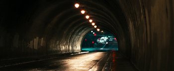 Movie still from “Set It Off” (1996), directed by F. Gary Gray – A helicopter is flying through a tunnel at night; Extreme Wide shot, High angle