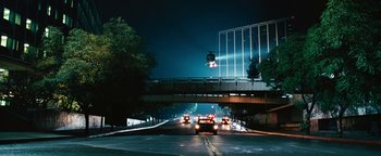 Movie still from “Set It Off” (1996), directed by F. Gary Gray – Cars are driving on a street under a bridge at night; Extreme Wide shot, Low angle