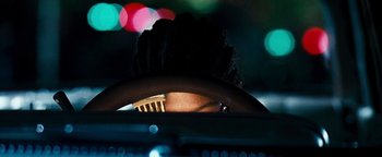 Movie still from “Set It Off” (1996), directed by F. Gary Gray – A person with a brush in their hair; Extreme Close Up shot, Overhead angle