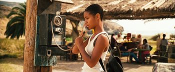Movie still from “Set It Off” (1996), directed by F. Gary Gray – A young woman holding a microphone to her ear; Close Up shot, Low angle