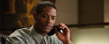 Movie still from “Set It Off” (1996), directed by F. Gary Gray – A man holding a phone up to his ear; Close Up shot, Low angle