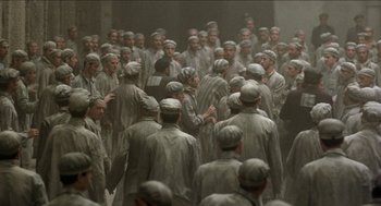 A large group of men in grey suits and hats