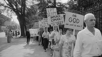 Movie still from “Seven Days in May” (1964), directed by John Frankenheimer – A black and white photo of people holding protest signs; Medium shot, High angle