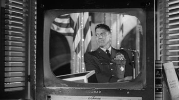 Movie still from “Seven Days in May” (1964), directed by John Frankenheimer – A black - and - white photo of a man in uniform; Medium shot, Low angle