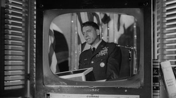 Movie still from “Seven Days in May” (1964), directed by John Frankenheimer – A black - and - white photo of a man in uniform; Medium shot, Low angle