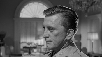 Movie still from “Seven Days in May” (1964), directed by John Frankenheimer – An old photo of a man in a military uniform looking to his left; Close Up shot, Low angle