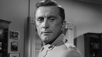 Movie still from “Seven Days in May” (1964), directed by John Frankenheimer – An old black and white photo of a man in a uniform; Close Up shot, Low angle
