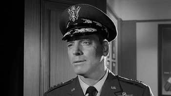Movie still from “Seven Days in May” (1964), directed by John Frankenheimer – A man in a military uniform is looking at the camera; Close Up shot, Low angle