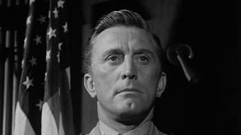 Movie still from “Seven Days in May” (1964), directed by John Frankenheimer – An old photo of a man in a military uniform; Close Up shot, Low angle