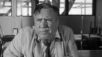 Movie still from “Seven Days in May” (1964), directed by John Frankenheimer – An older man in a striped jacket and a tie; Close Up shot, Over the shoulder angle