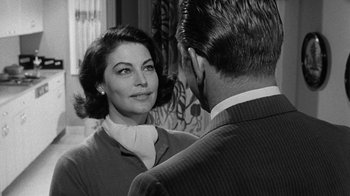 Movie still from “Seven Days in May” (1964), directed by John Frankenheimer – An old photo of a man and a woman looking at each other; Close Up shot, Over the shoulder angle