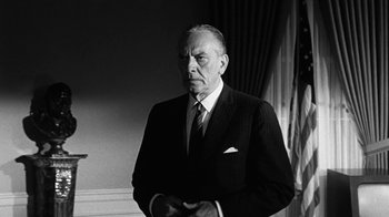 Movie still from “Seven Days in May” (1964), directed by John Frankenheimer – An older man wearing a suit and tie; Medium shot, Low angle