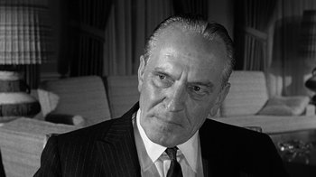 Movie still from “Seven Days in May” (1964), directed by John Frankenheimer – An older man wearing a suit and tie; Close Up shot, Low angle