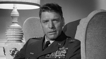 Movie still from “Seven Days in May” (1964), directed by John Frankenheimer – Black and white photograph of a man in military uniform; Close Up shot, Low angle