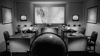 Movie still from “Seven Days in May” (1964), directed by John Frankenheimer – A room filled with lots of desks and a globe; Extreme Wide shot, High angle