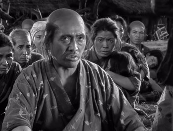 Movie still from “Seven Samurai” (1954), directed by Akira Kurosawa – A group of people standing in a field; Close Up shot, Low angle