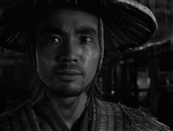 Movie still from “Seven Samurai” (1954), directed by Akira Kurosawa – A black and white photo of a man wearing a hat; Close Up shot, Low angle