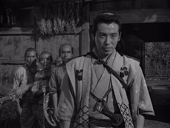 Movie still from “Seven Samurai” (1954), directed by Akira Kurosawa – Black and white photograph of a man in traditional japanese garb; Medium shot, Low angle