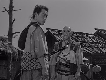 Movie still from “Seven Samurai” (1954), directed by Akira Kurosawa – Two men in traditional japanese garb standing next to each other; Medium shot, Low angle