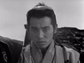 Movie still from “Seven Samurai” (1954), directed by Akira Kurosawa – A black and white photo of a man in a kimono; Close Up shot, Low angle