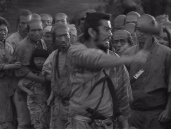 Movie still from “Seven Samurai” (1954), directed by Akira Kurosawa – Black and white photograph of a group of people; Medium shot, High angle