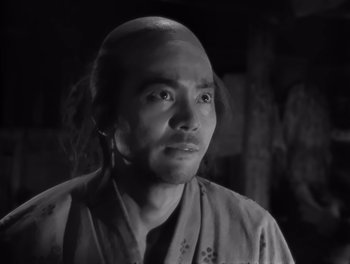 Movie still from “Seven Samurai” (1954), directed by Akira Kurosawa – A black and white photo of a man in a kimono; Close Up shot, Low angle