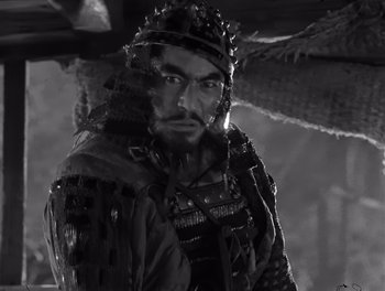 Movie still from “Seven Samurai” (1954), directed by Akira Kurosawa – A black and white photo of a man wearing a helmet; Close Up shot, Low angle