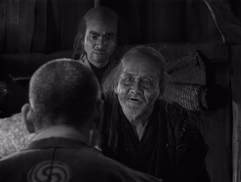 Movie still from “Seven Samurai” (1954), directed by Akira Kurosawa – A man and a woman talking to another man; Close Up shot, Over the shoulder angle