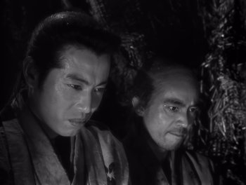 Movie still from “Seven Samurai” (1954), directed by Akira Kurosawa – Two men in traditional garb looking at each other; Close Up shot, Low angle
