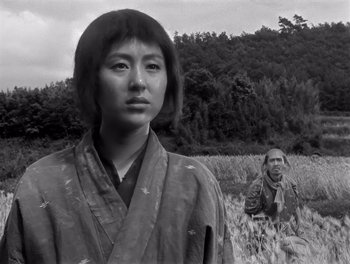 Movie still from “Seven Samurai” (1954), directed by Akira Kurosawa – A woman in a kimono standing next to a man in a field; Medium shot, Low angle