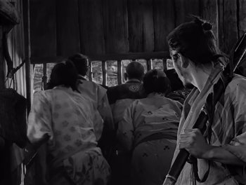 Movie still from “Seven Samurai” (1954), directed by Akira Kurosawa – A group of people sitting in a room; Medium shot, Low angle
