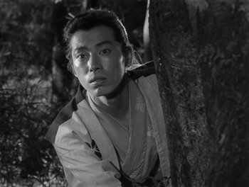 Movie still from “Seven Samurai” (1954), directed by Akira Kurosawa – A man in a kimono leaning against a tree; Close Up shot, Low angle