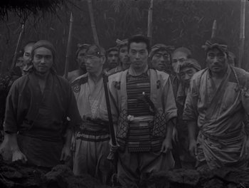 Movie still from “Seven Samurai” (1954), directed by Akira Kurosawa – A black and white photo of a group of people; Wide shot, High angle