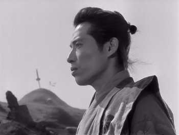 Movie still from “Seven Samurai” (1954), directed by Akira Kurosawa – Black and white photograph of a man in a military outfit; Close Up shot, Low angle