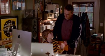 Movie still from “Sex Tape” (2014), directed by Jake Kasdan – A man and a boy in front of a laptop computer in a room; Medium shot, Over the shoulder angle
