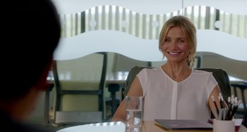 Movie still from “Sex Tape” (2014), directed by Jake Kasdan – A woman sitting at a table with a glass in front of her; Medium shot, Over the shoulder angle