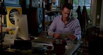 Movie still from “Sex Tape” (2014), directed by Jake Kasdan – A man sitting in front of a computer desk; Medium shot, High angle